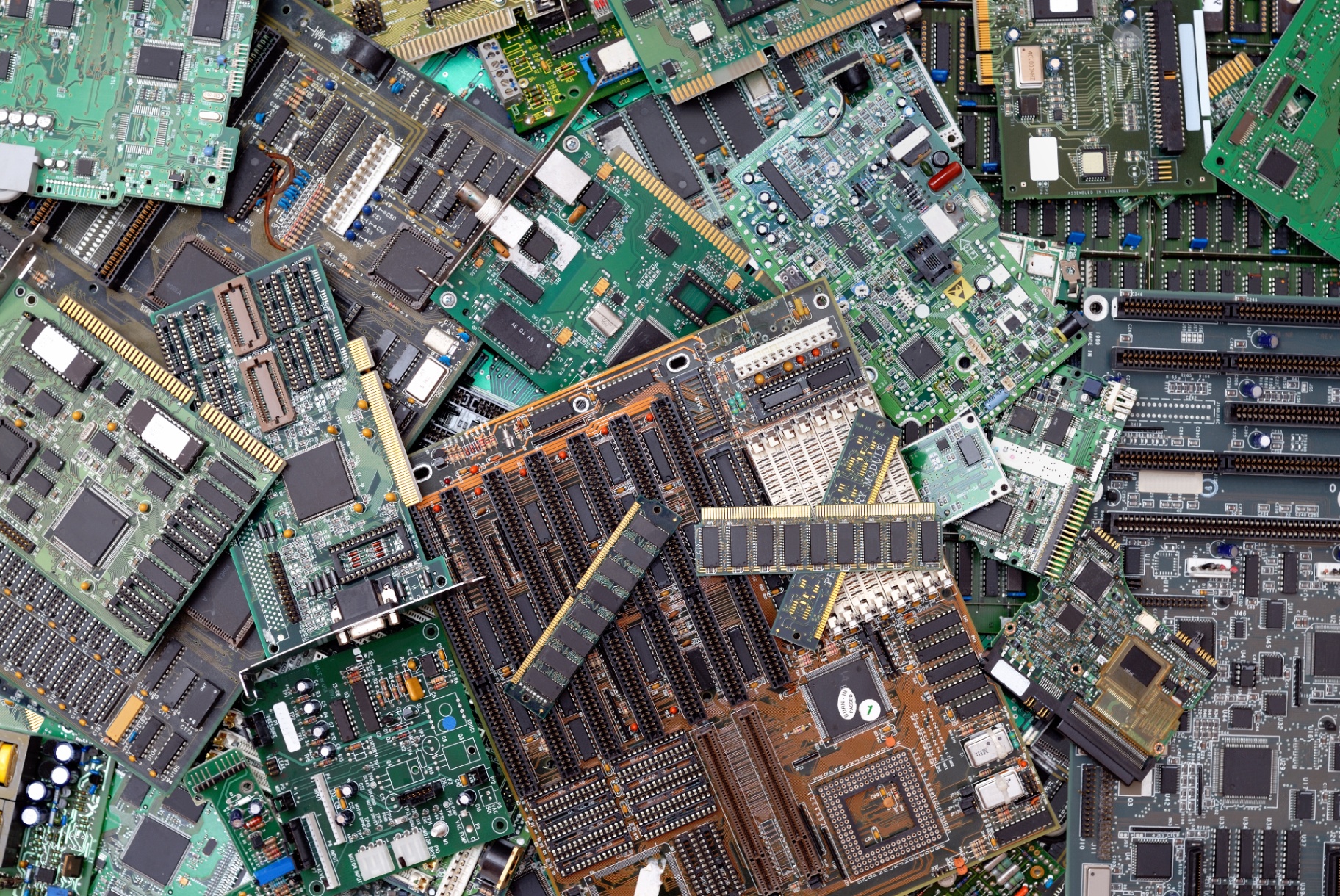 Stacks of end-of-life printed circuit boards awaiting secure destruction and critical materials recovery